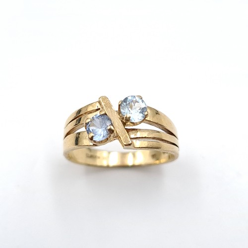 34 - Star Lot : An unusual three band nine carat gold two stone aquamarine ring. Ring size - O. Weight - ... 