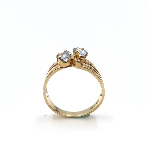 34 - Star Lot : An unusual three band nine carat gold two stone aquamarine ring. Ring size - O. Weight - ... 