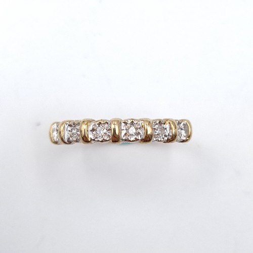 35 - Star Lot : A six diamond half eternity ring set in nine carat gold. 'DIA' stamped to band. Ring size... 