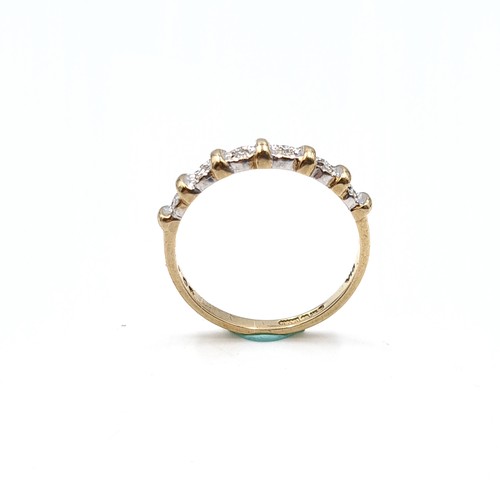 35 - Star Lot : A six diamond half eternity ring set in nine carat gold. 'DIA' stamped to band. Ring size... 