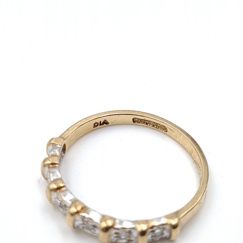 35 - Star Lot : A six diamond half eternity ring set in nine carat gold. 'DIA' stamped to band. Ring size... 