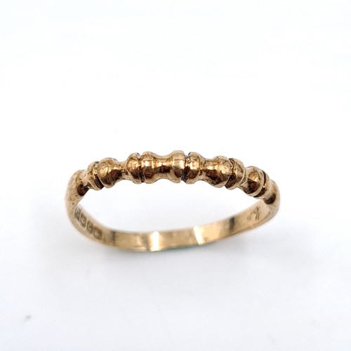 36 - A nine carat twist set gold ring. Size - N. Weight - 1.17 grams. Boxed.