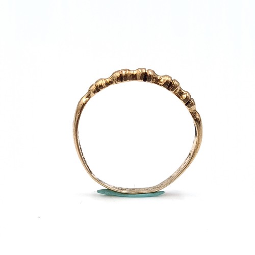 36 - A nine carat twist set gold ring. Size - N. Weight - 1.17 grams. Boxed.