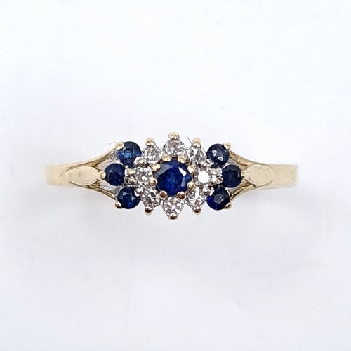 38 - Star Lot : A nine carat gold diamond and sapphire ring in cluster mount. Size - L 1/2. Weight - 1.43... 