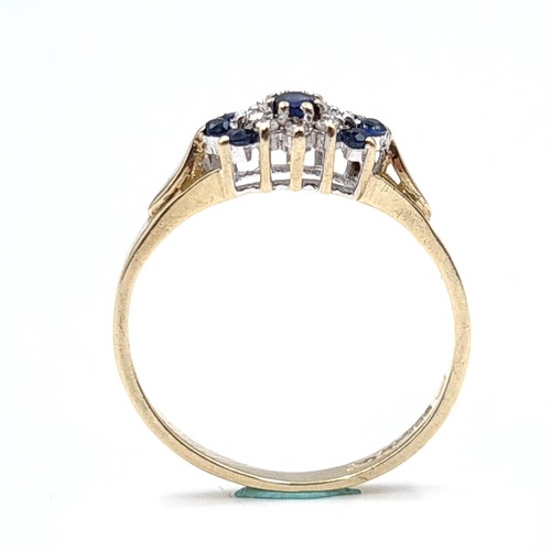 38 - Star Lot : A nine carat gold diamond and sapphire ring in cluster mount. Size - L 1/2. Weight - 1.43... 