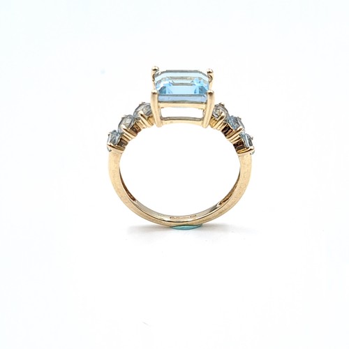 44 - A very pretty  example of a blue topaz seven stone ing set with topaz shoulders set in nine carat go... 