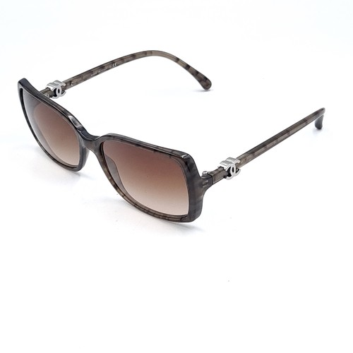 52 - A pair of designer Chanel sunglasses. Frames marked with serial nos. Lenses in good, clean condition... 