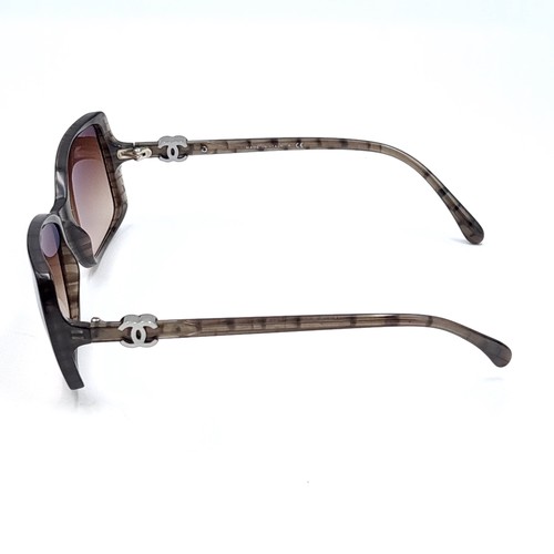 52 - A pair of designer Chanel sunglasses. Frames marked with serial nos. Lenses in good, clean condition... 