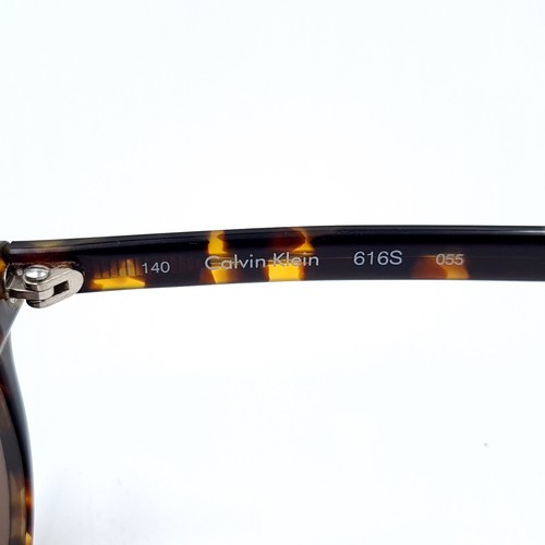 54 - A pair of Calvin Klein sunglasses with faux tortoise shell frames. Lenses clear. Overall condition i... 