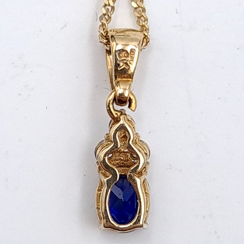 595 - Star Lot : A beautiful nine carat gold sapphire & diamond pendant necklace. Length of chain - 44 cms... 