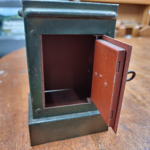 652 - A charming vintage money box stamped 'Modele Depose' in the form of a safe. With lock and key in wor... 