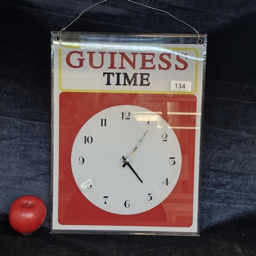 134 - A printed Perspex wall clock reading Guinness Time.