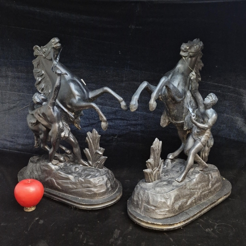 135 - A pair of large cast metal Marley Horses on wooden bases. Very impressive.