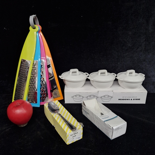 198 - A mixed lot of homeware items including a set of colorful cheese graters and a set of three Meadows ... 