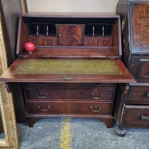 466 - A quality vintage writing desk with four drawers featuring brass handles, bracket feet and nice done... 