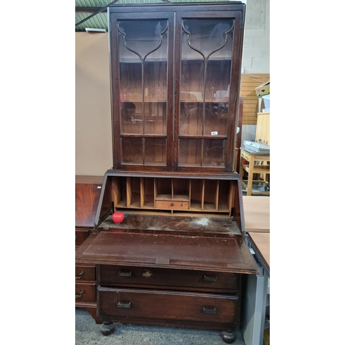 467 - A vintage astra glazed writing desk with added display cabinet features three drawers, writing secti... 