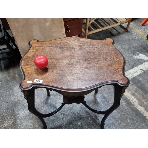 609 - Star Lot : A Victorian Side Table with ornate brass accents, scalloped wooden top, and elegant cabri... 