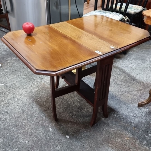 614 - A handsome skinny vintage drop-leaf occasional table made of polished wood with fluted legs .