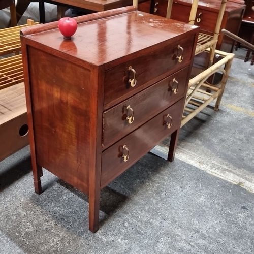 618 - A three-drawer wooden chest featuring bras handles and a warm patina.