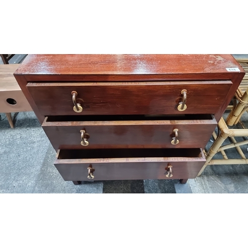 618 - A three-drawer wooden chest featuring bras handles and a warm patina.