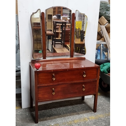 625 - A Vintage mid century oak dressing table with tri-fold beveled mirrors, brass ring handles, and two ... 