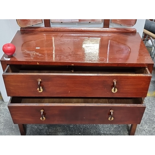 625 - A Vintage mid century oak dressing table with tri-fold beveled mirrors, brass ring handles, and two ... 