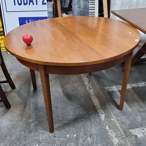 629 - Star Lot : A fab Mid Century extendable Teak Dining Table from the 1960s. Circular design with a cen... 