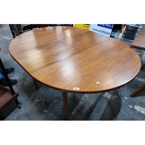 629 - Star Lot : A fab Mid Century extendable Teak Dining Table from the 1960s. Circular design with a cen... 