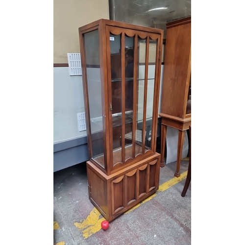 632 - A lovely art deco display cabinet featuring glass doors, shelves, and wonderful scalloped accents. C... 