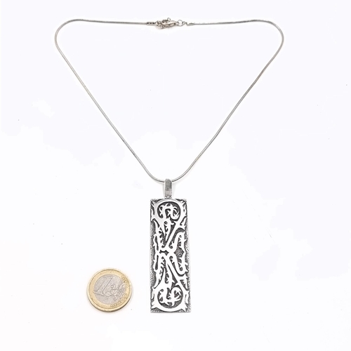 17 - A large sterling silver ingot style pendant set with interwoven design  and chain. Length of chain -... 