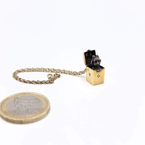 22 - Star Lot : A very rare 14ct gold bracelet with a charm attached of a box with a flip top with a pop ... 