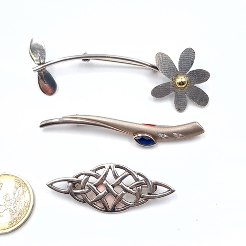 40 - Three sterling silver brooches. One with gem set detailing. Total weight - 16.46 grams. Pins intact.