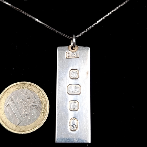 548 - A sterling silver ingot with sterling silver chain hallmarked Sheffield. Length - 40 cms. Weight - 3... 