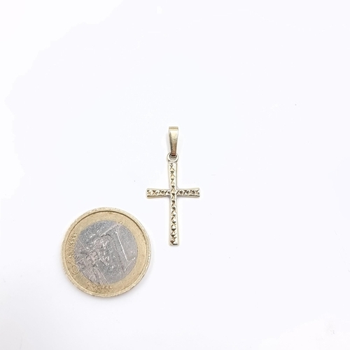 23 - A nine carat gold 375 cross. Dimensions: L - 2.5 cms. Weight - 1.33 grams.