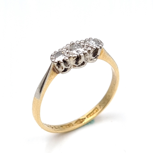 645 - Star Lot : A three stone 18 carat gold diamond ring. Size - M. Weight - 1.76 grams. Boxed.