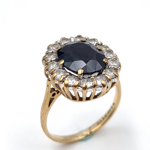 648 - Star Lot : A large sapphire stone ring with gem set surround set in nine carat gold (375). Ring size... 