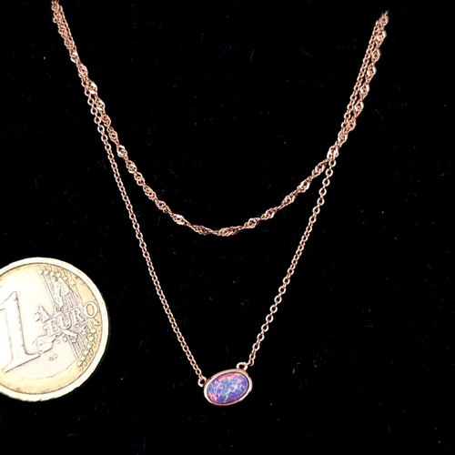 660 - An antique purple fire opal stone pendant with rose gold plated chain. Length - 44 cms. Boxed.