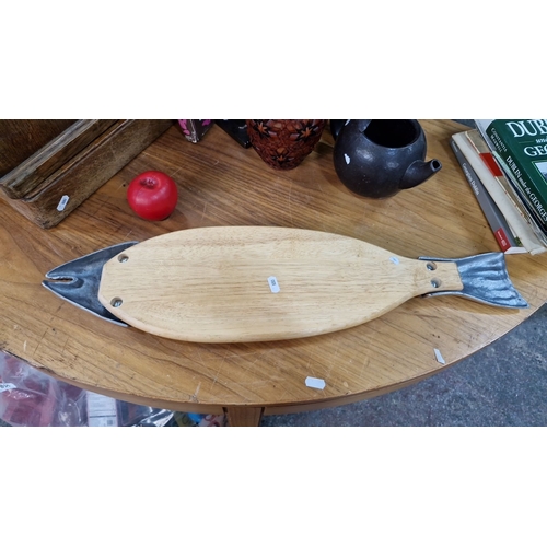 852 - A Fish-shaped carving board with a wooden base and detailed silver-plated head and tail accents.