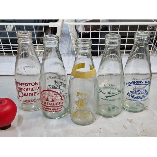 865 - Vintage Irish milk bottles featuring various dairy logos, including Emerton Murchfield, Home Farm, P... 