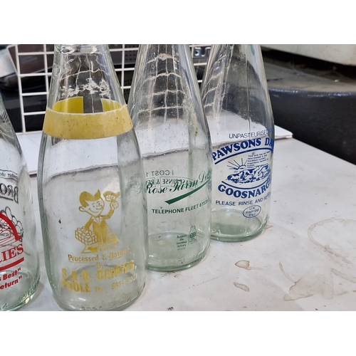 865 - Vintage Irish milk bottles featuring various dairy logos, including Emerton Murchfield, Home Farm, P... 