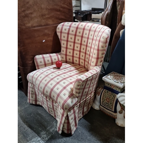 675 - A lovely wingback armchair with floral-checkered upholstery and skirting detail. In very clean condi... 