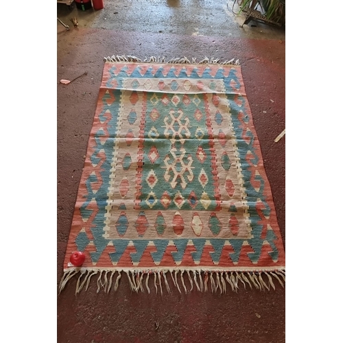 677 - Handwoven kilim rug with geometric tribal patterns in vibrant pastel tones, fringed edges, from the ... 