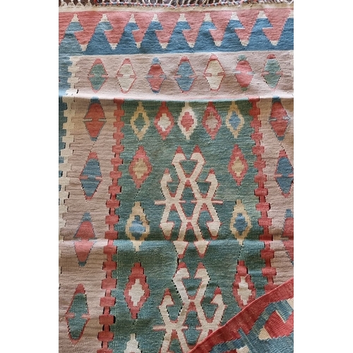 677 - Handwoven kilim rug with geometric tribal patterns in vibrant pastel tones, fringed edges, from the ... 