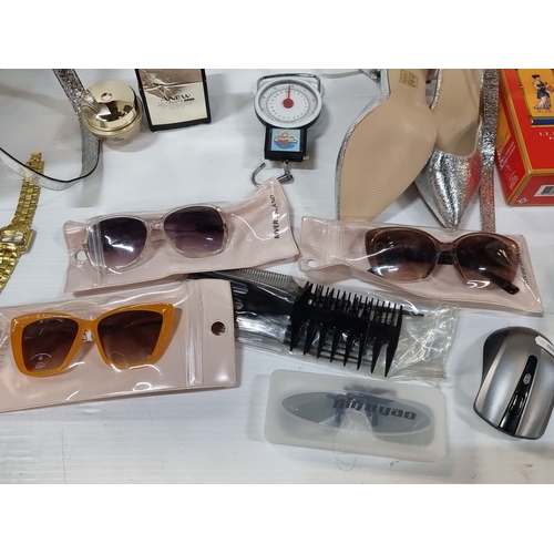 869 - Includes silver tote bag, metallic shoes, sunglasses, watches, combs, wireless mouse, perfumes, and ... 