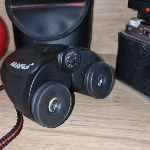 882 - Includes Agfa camera with Hanimex X215 flash, black leather case and a pair of compact binoculars.