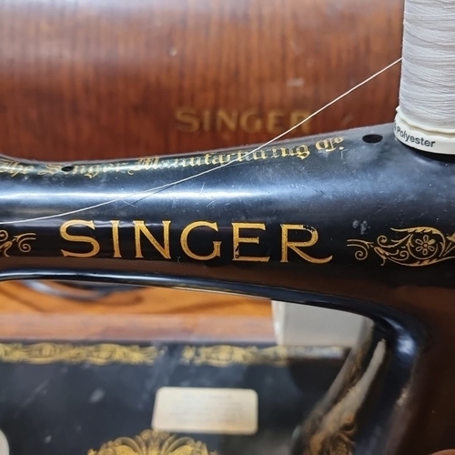 891 - Vintage Singer Sewing Machine with Wooden Case, from the 1940s. Hand-crank model featuring ornate go... 