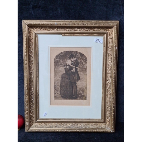 703 - A print of an original etching after an original photograph of a couple embracing. Housed in an orna... 