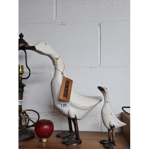 726 - A pair of fun wooden ducks. Label around neck reads 'Quackers'.