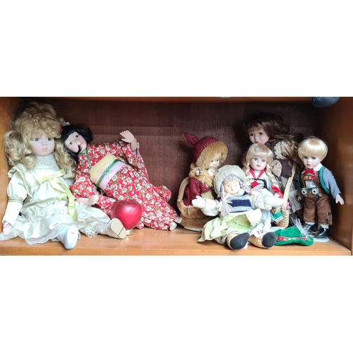 729 - Seven vintage porcelain faced dolls including a very pretty Japanese girl example with Kimono.