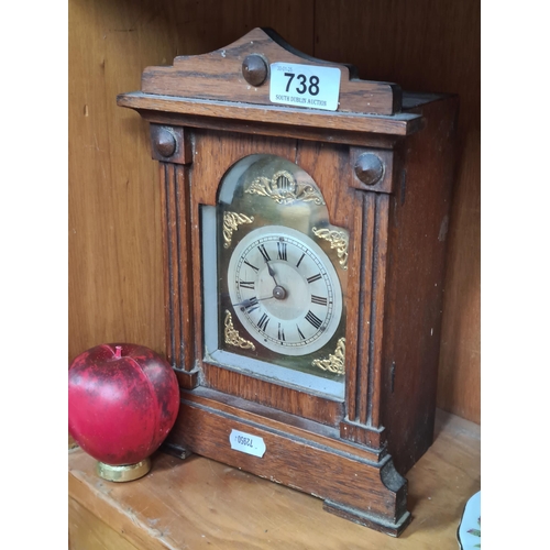 738 - A beautiful antique Irish made oak cased mantel clock. The clock face features a roman numeral dial ... 